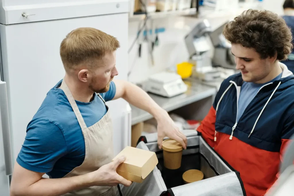 Kitchen team preparing and packing delivery orders in a multi-brand cloud kitchen