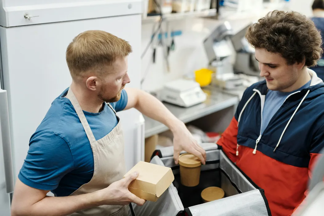 Kitchen team preparing and packing delivery orders in a multi-brand cloud kitchen